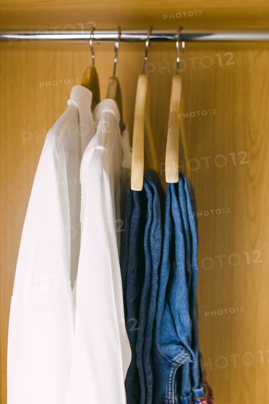 Clothes hanging in wardrobe