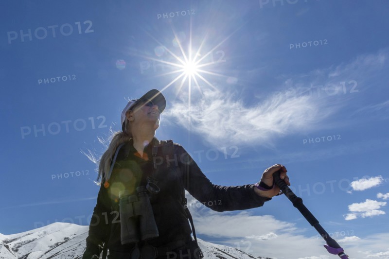 Low angle view of hiker on snow covered mountain