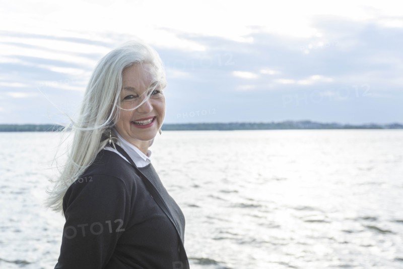 Smiling mature woman by Potomac River in Washington DC, USA