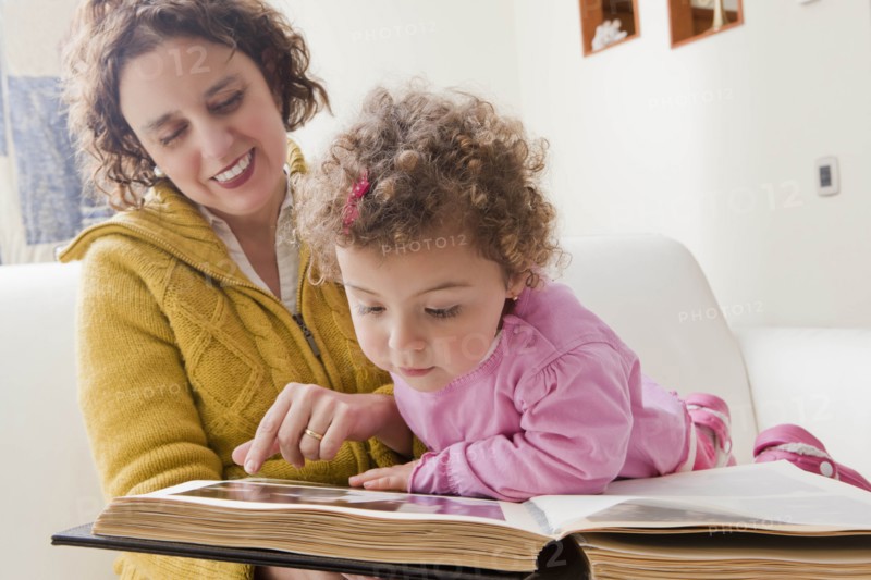 Mother and daughter reading picture book