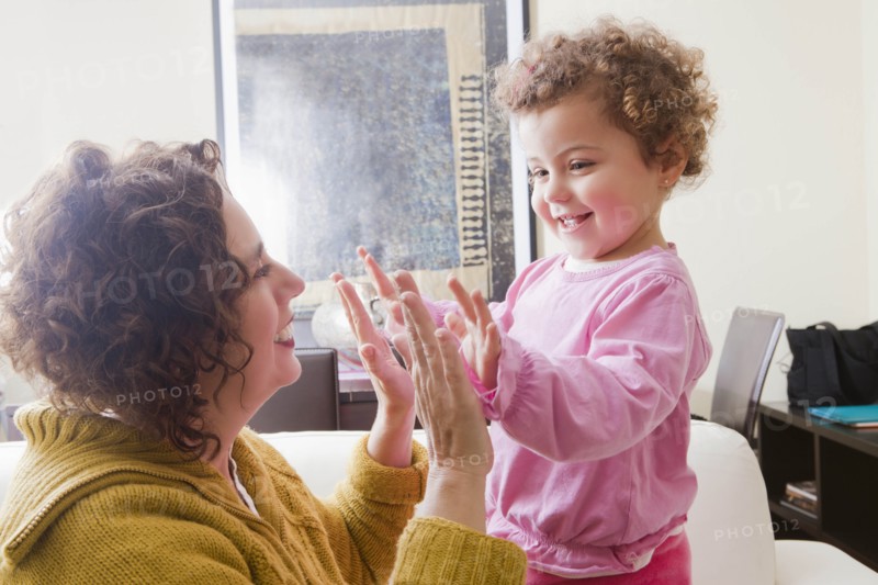 Mother and daughter playing clapping game