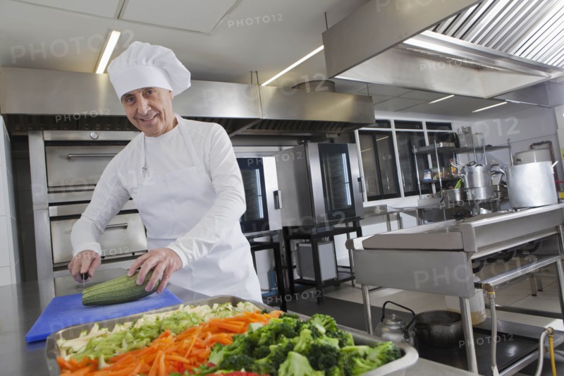 Chef slicing squash in commercial kitchen