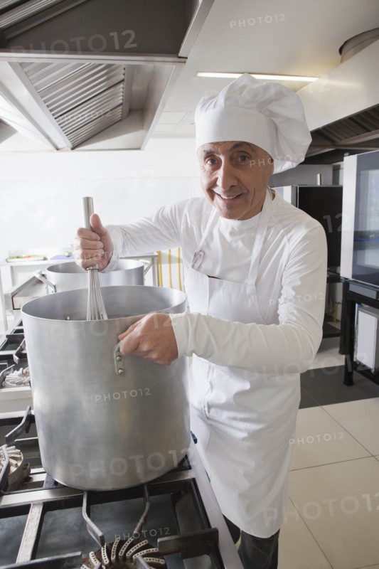 Chef using whisk in pot