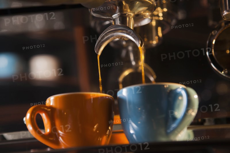 Coffee pouring from portafilter into coffee cups