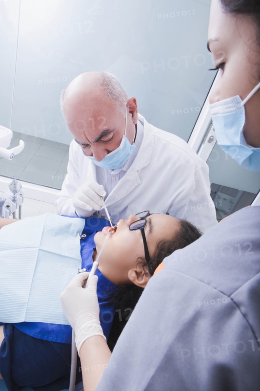 Teenage girl getting dental cleaning