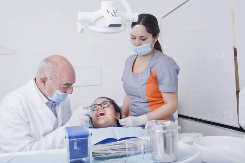 Teenage girl getting dental cleaning