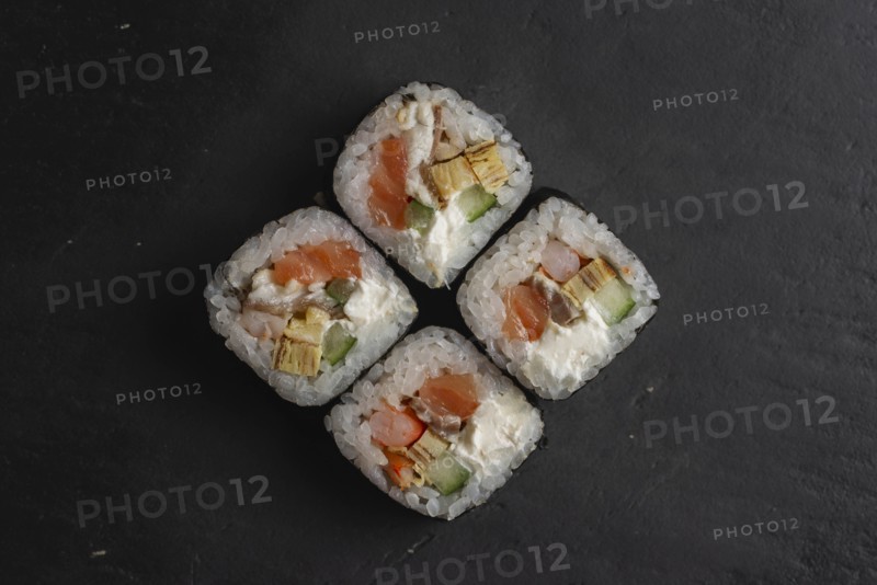 Salmon sushi on black surface