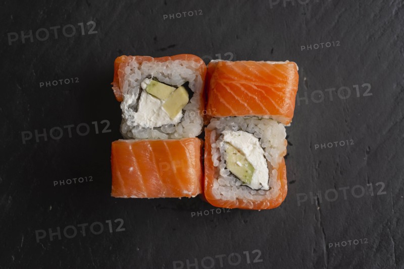 Salmon sushi on black surface