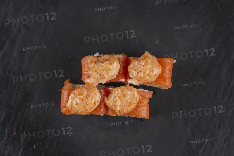 Salmon sushi with orange sauce