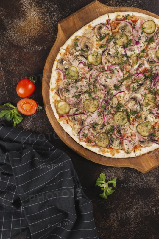 Pizza with pickles and red onion