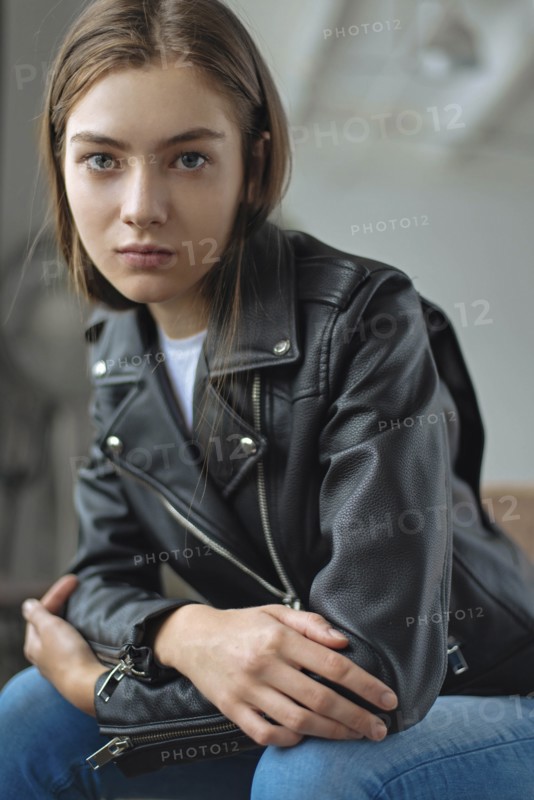 Young woman wearing black leather jacket