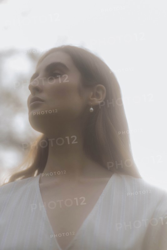 Brown haired young woman looking away