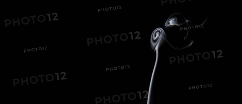 Smoke in spiral shapes against black background