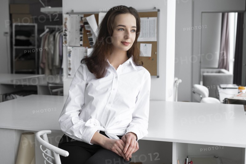 Fashion designer sitting at desk