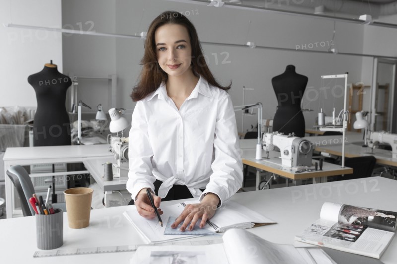 Fashion designer working at desk in studio