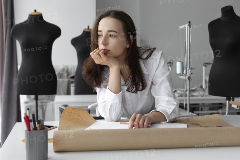 Fashion designer thinking at desk