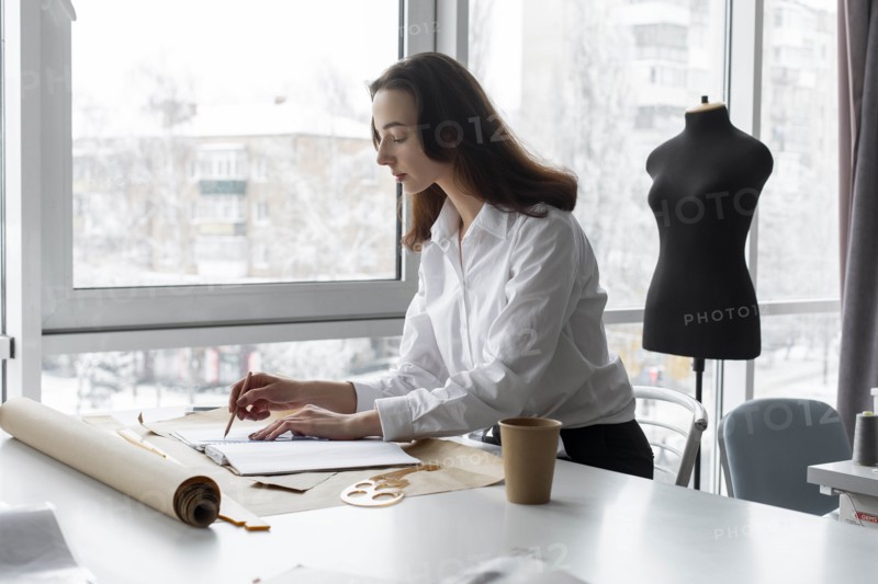 Fashion designer working at desk in studio