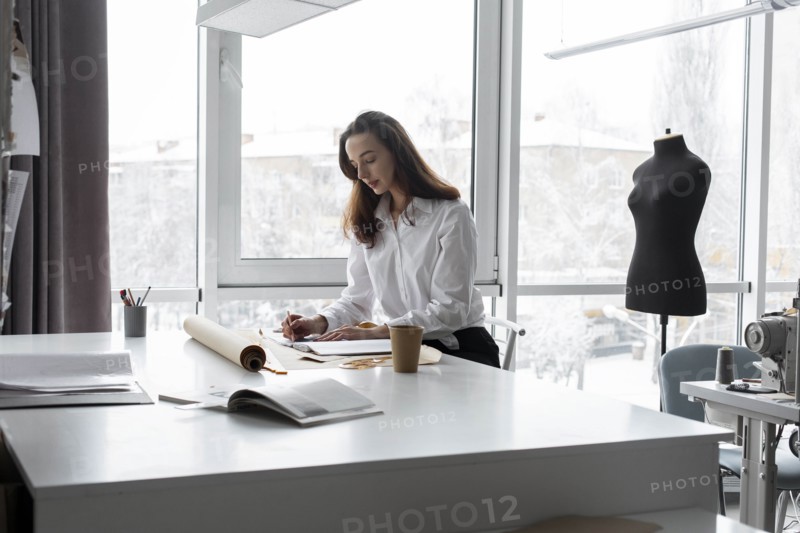 Fashion designer working at desk in studio