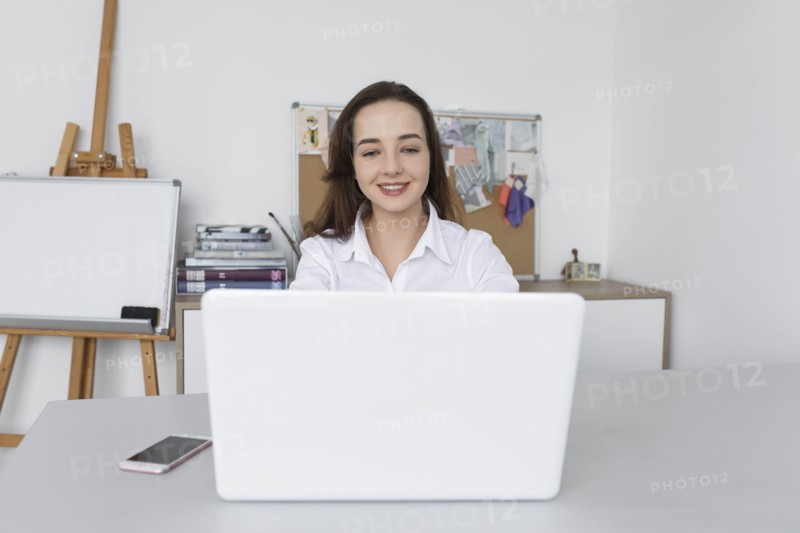 Fashion designer working at laptop