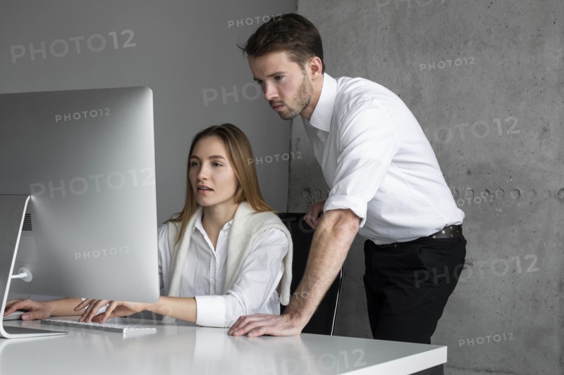 Businesspeople using computer together