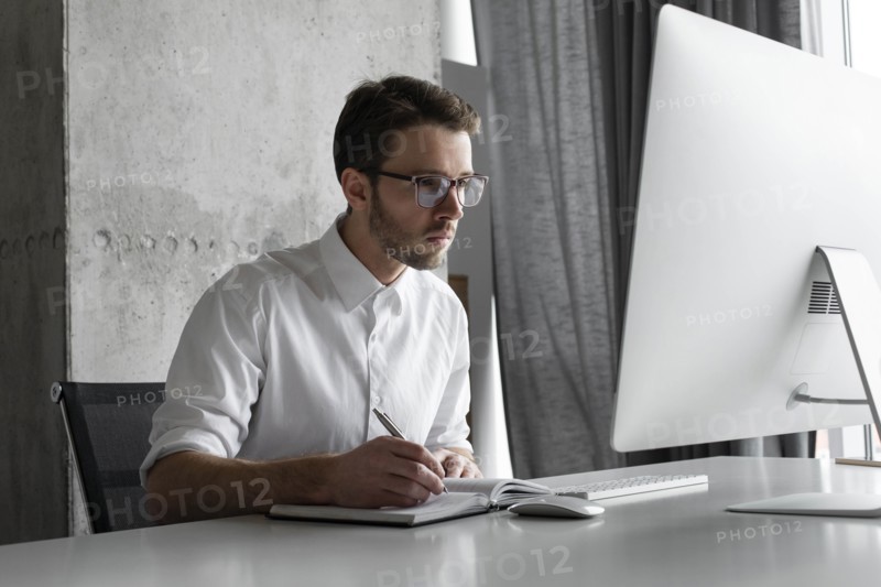 Businessman writing in notebook