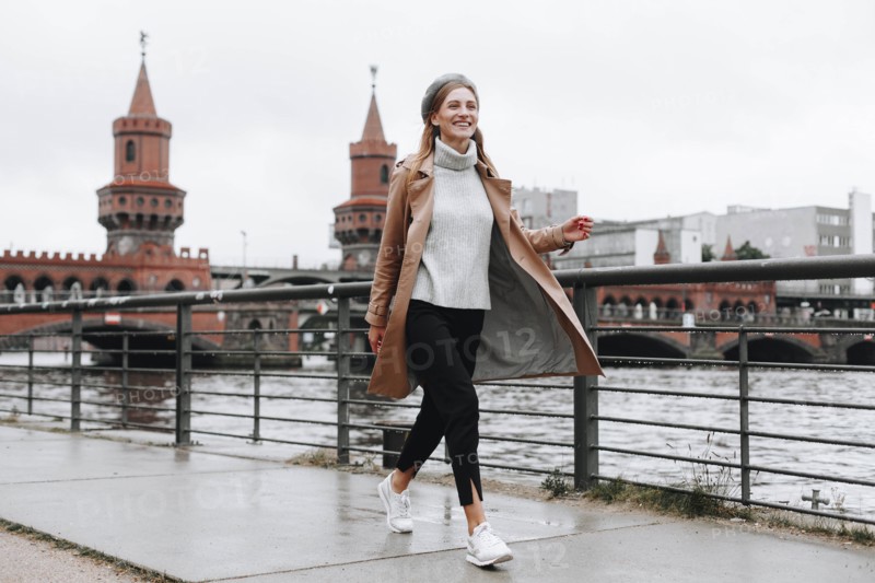 Young woman walking by river in Berlin, Germany