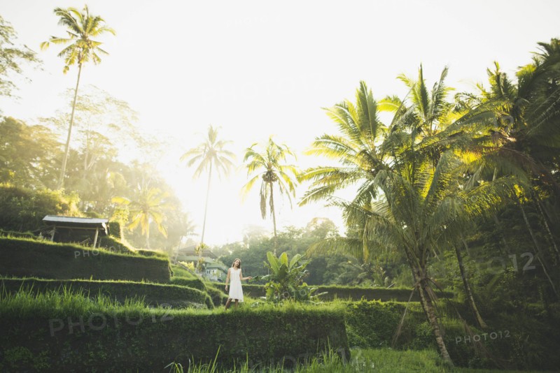 Woman wearing white dress on terraced rice paddies in Bali, Indonesia