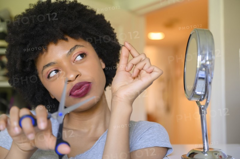 Young woman contemplating cutting her hair