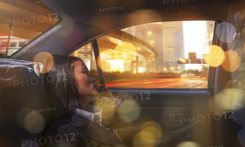 Businesswoman on phone call in taxi