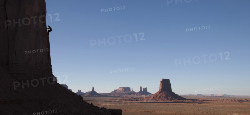 Silhouette of rock climber in Monument Valley Navajo Tribal Park, USA