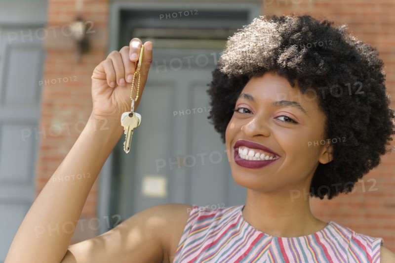 Smiling young woman holding keys