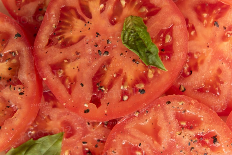 Sliced tomatoes with basil and pepper