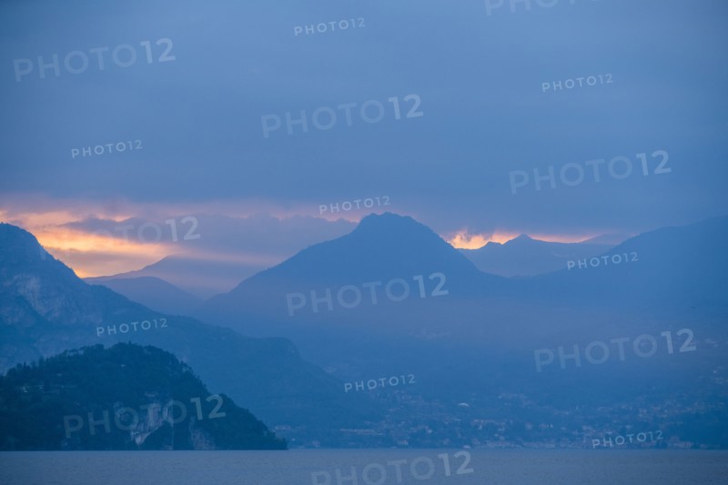 Sunset sky over mountains by Lake Como, Italy