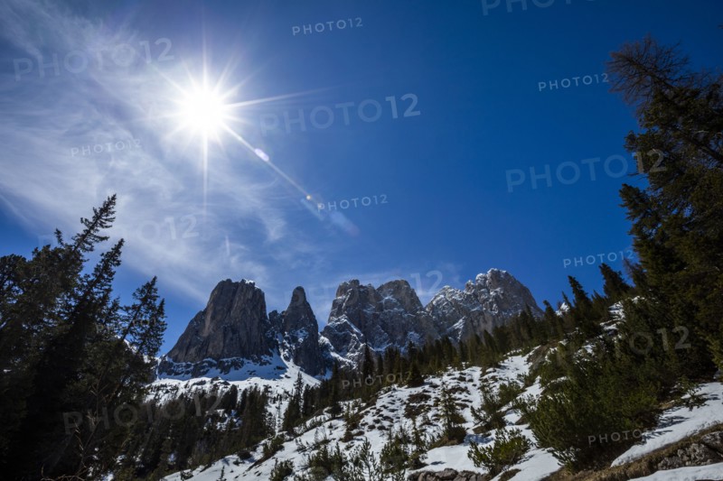 Sun over mountain range in Dolomites, Italy