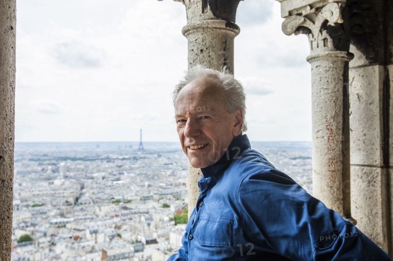 Smiling man by cityscape from Sacre Coeur in Paris, France