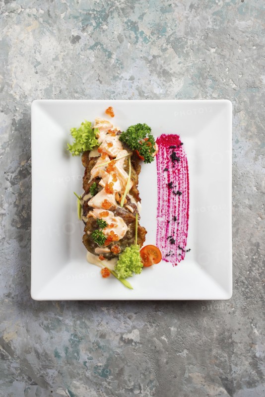 Fish cakes with sauce and caviar