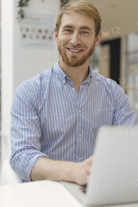 Smiling man using laptop
