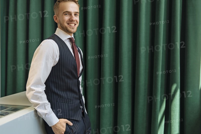Smiling man wearing pinstripe waistcoat in store