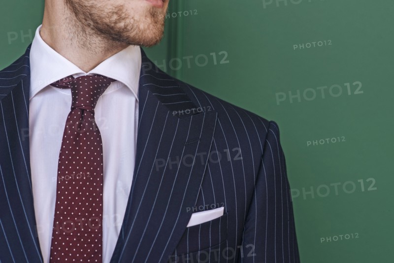 Man wearing pinstripe blazer with spotted tie