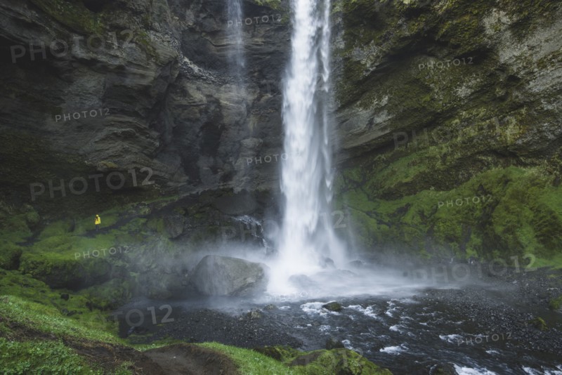 Woman by Kvernufoss waterfall in Iceland