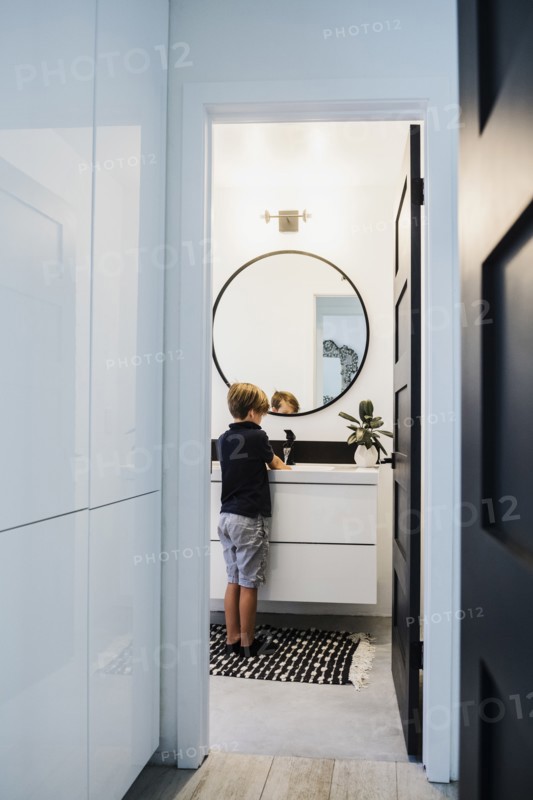 Boy washing his hands in bathroom