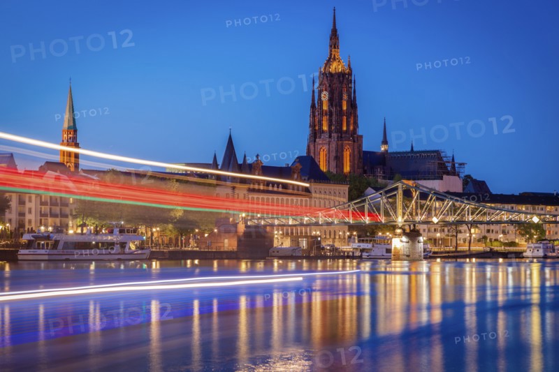 Light trails on river at sunset in Frankfurt