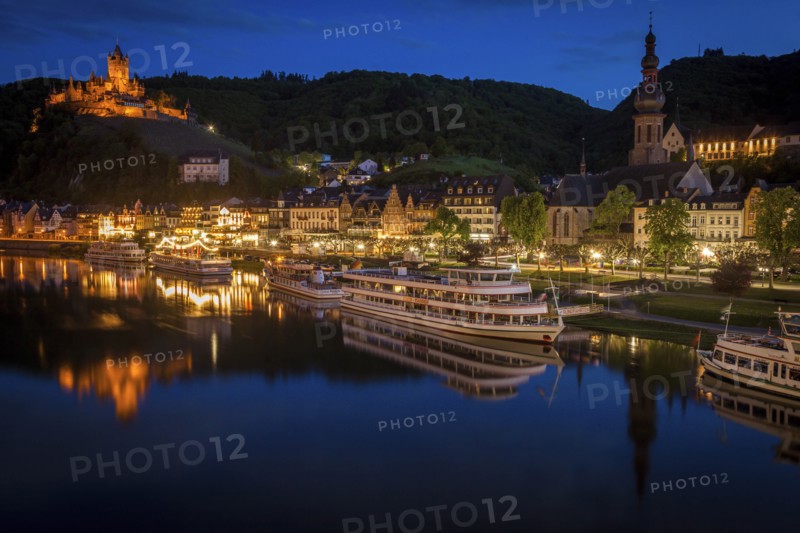 Town and Cochem Imperial Castle by river at sunset in Cochem