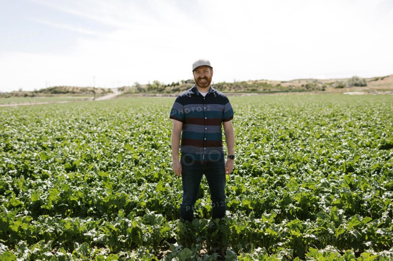 Smiling mid adult man in crop field