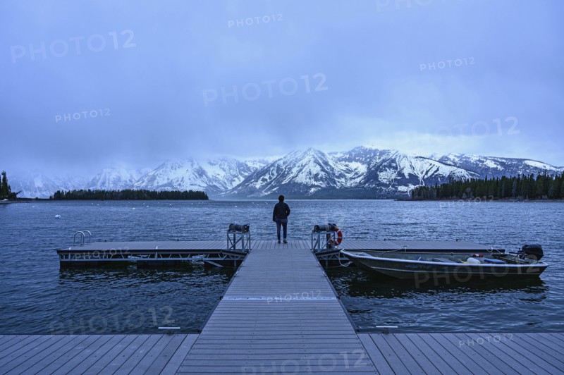 Woman standing on jetty on Jenny Lake in Grand Teton National Park