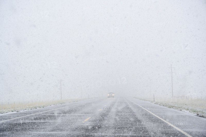 View through windscreen of car on highway during snow