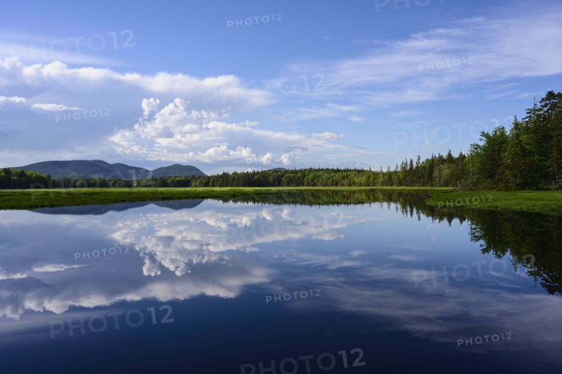 Clouds reflected in lake in Acadia National Park