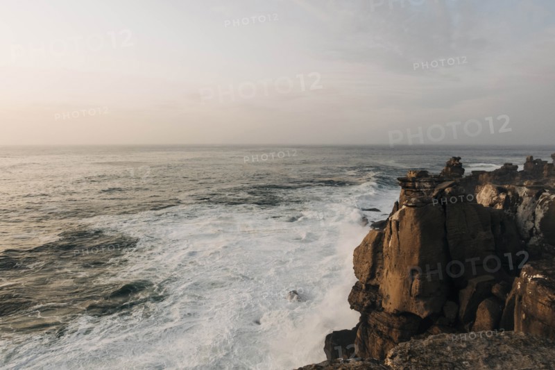 Cliff by sea at sunset in Peniche
