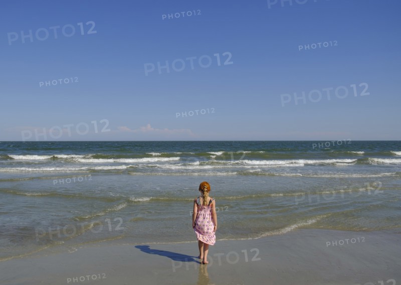 Rear view of girl walking on beach