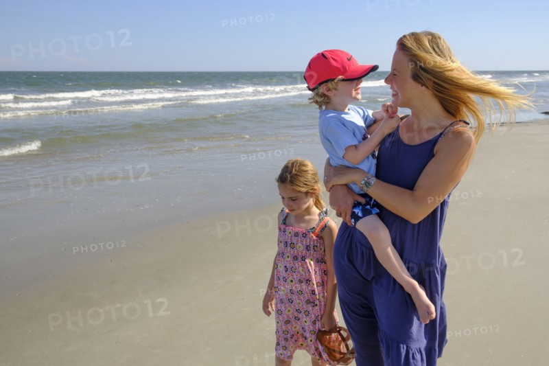 Mother and children walking on beach